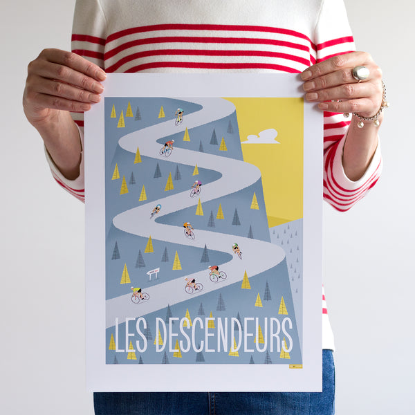 Woman holding 30 x 40cm Descenders cycling print