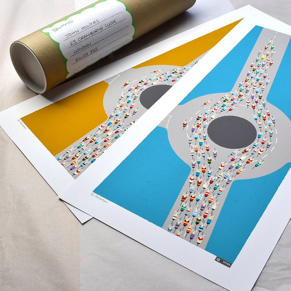 Two Peloton Roundabout cycling prints, in mid century blue and mid century mustard colourways, with  packaging