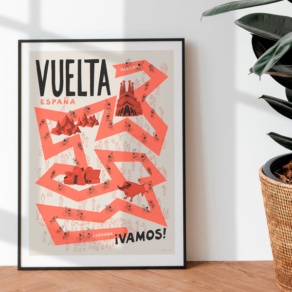 Framed poster with 'Vuelta Espana' design on a wall next to a plant