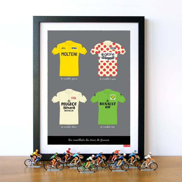 Cycling print featuring four classic jerseys of the Tour de France. Shown in a black frame and displayed with vintage die cast cycling figures