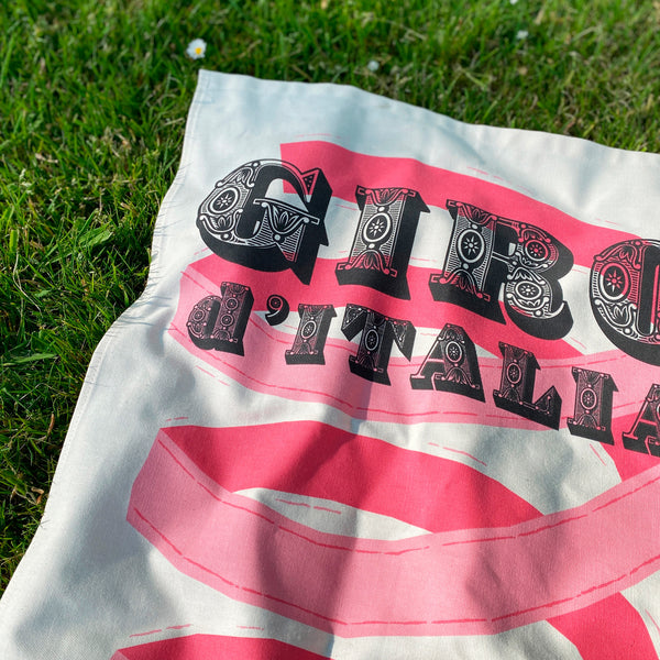 Cycling Grand Tour natural cotton tea towel, close up detail of decorative font 'Giro d'Italia', photographed on grass