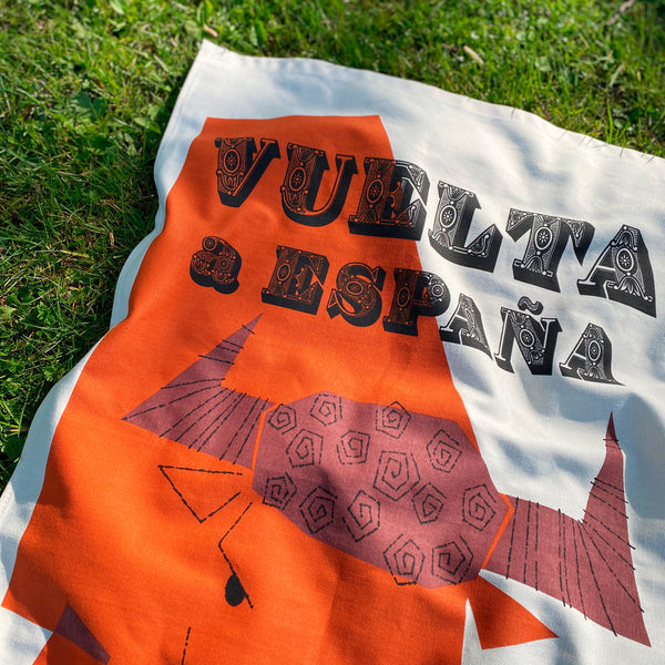 Cycling Grand Tour natural cotton tea towel, close up detail of decorative font, 'Vuelta a Espana', photographed on grass